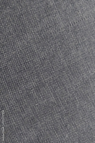 Close-up view of textured fabric revealing detailed weave pattern in a dark shade suitable for design and textile analysis