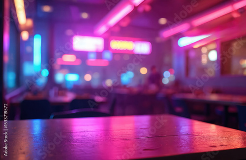 Modern nightclub restaurant table with neon purple light. Interior bar background with vivid pink and blue lights. Empty table, product placement concept for drinks or food. photo