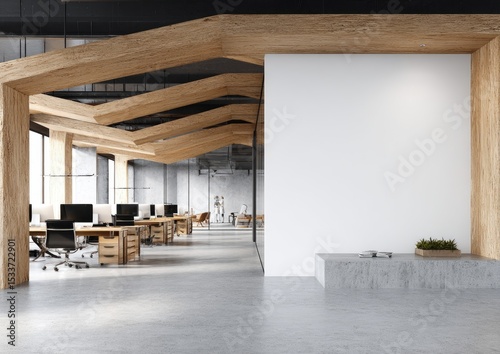 Modern office interior with exposed beams, concrete floors, and a large blank wall, showcasing minimalist workstations and natural wood accents