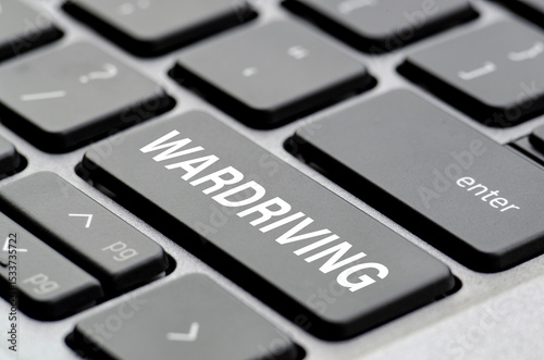 Wardriving text on laptop keyboard indicating where users can be redirected unknowingly to fake websites photo