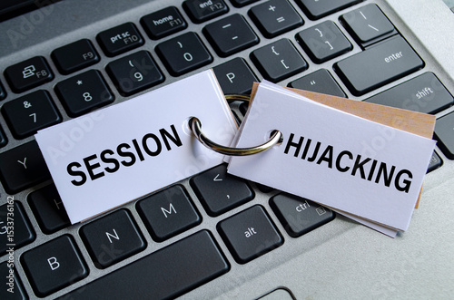 Session hijacking text on white notepad with laptop keyboard background. Hacker and scam activity concept