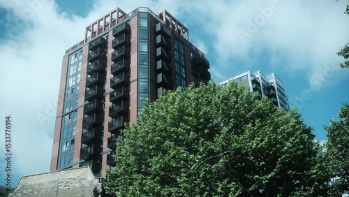 A highly detailed, professional photograph of a tall building with a lot of windows captured with artistic lighting and excellent composition. the scene features  under moody and dramatic conditions.