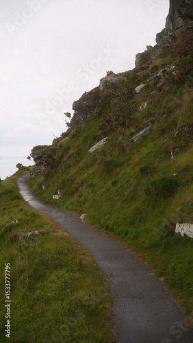 A highly detailed, professional photograph of a person riding a horse down a road captured with artistic lighting and excellent composition. the scene features  under moody and dramatic conditions.