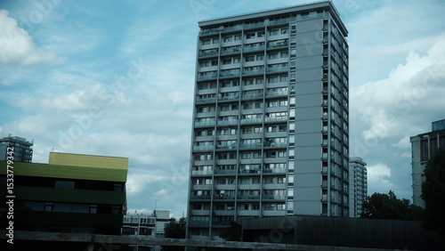 A highly detailed, professional photograph of a tall building with a lot of windows captured with artistic lighting and excellent composition. the scene features  under moody and dramatic conditions.