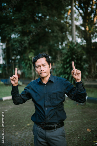 Enthusiastic man pointing upward, illustrating a bright idea or eureka moment