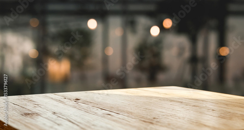 Dark wood planks with blurry indoor garden