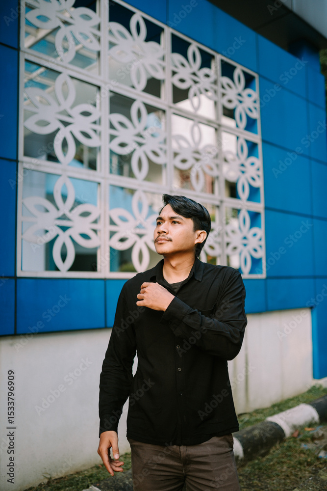 Fototapeta premium Thoughtful Young Man Contemplating Future Aspirations near Modern Building