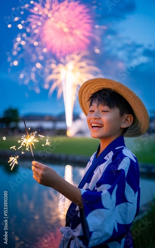Celebrating summer festival with fireworks and sparklers asian boy in yukata kimono japan