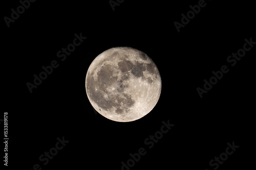 Full moon close up with craters and detail in a black sky