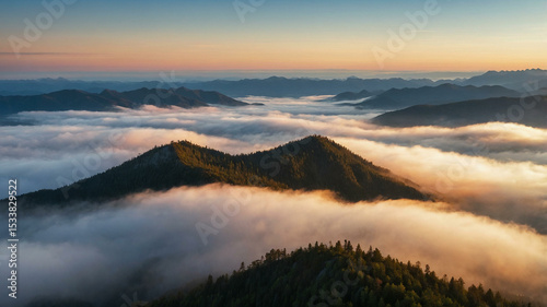 Aerial View of Mountain Peaks Emerging from Clouds at Sunrise
