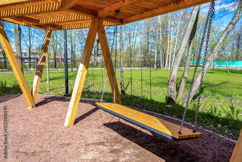 Fototapeta Naklejka Na Ścianę i Meble -  Wooden modern bench in the park. Landscape design