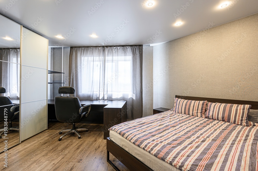 modern bedroom with a bed, desk, office chair, and closet. Natural light filters through the window, creating a bright and comfortable space modern bedroom with a bed, desk, office chair, and closet. Natural light filters through the window, creating a bright and comfortable space