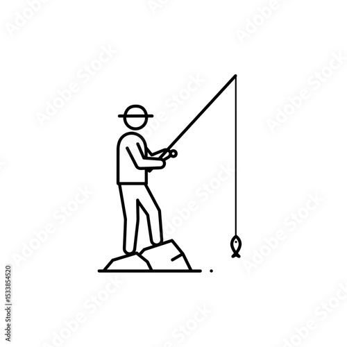 Man fishing while standing on rocks by the water's edge  