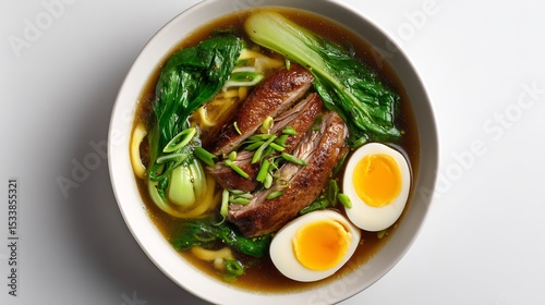 Vietnamese duck noodle soup mi vit tiem egg noodles braised duck leg and bok choy in herbal broth white background top down view