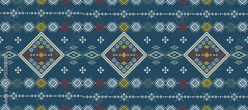 Traditional geometric textile pattern with diamond shapes and intricate symmetrical designs in blue, red, white, and yellow colors.