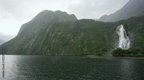 Majestic mountain with cascade flowing and foggy in Milford Sound at Fiordland national park, New Zealand