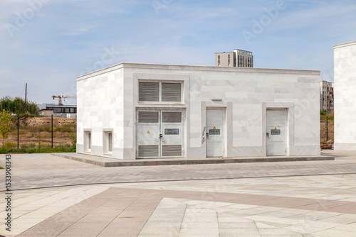 The trapezoidal building is used as a powerful electrical distributor. Isolated on white
