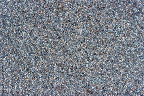 Gray and black stone surface with a few brown specks
