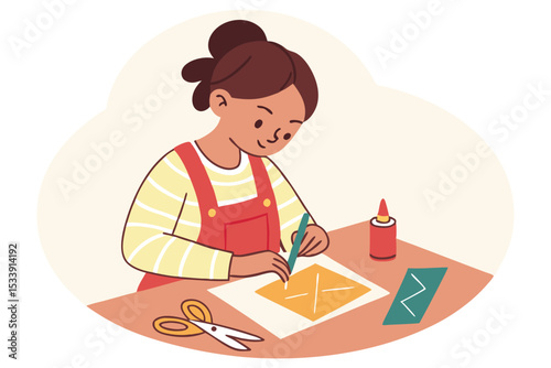 Girl engaged in arts and crafts project with paper cutting and gluing