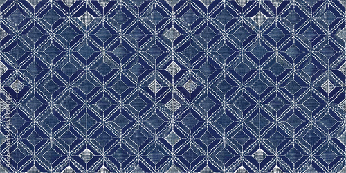 Intricate blue and white geometric pattern on fabric.