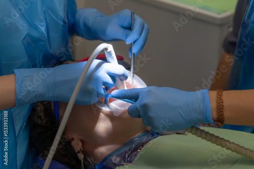 Woman receiving dental treatment in a clinic with expert care and technology