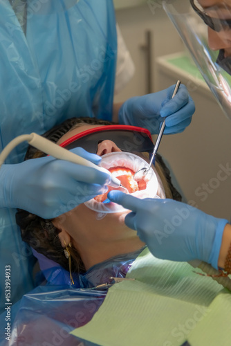 Woman receiving dental care in a modern clinic with professional staff