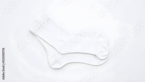 A pair of crisp white ribbed socks, neatly folded, isolated on white background