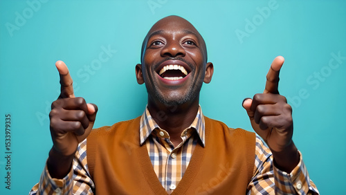 A old man is joyfully pointing upwards with his fingers while wearing a big smile on his face, radiating happiness and positivity