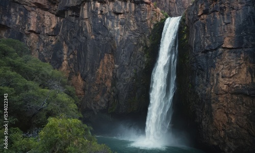 Majestic waterfall cascades down a rocky cliff face in Litchfield National Park