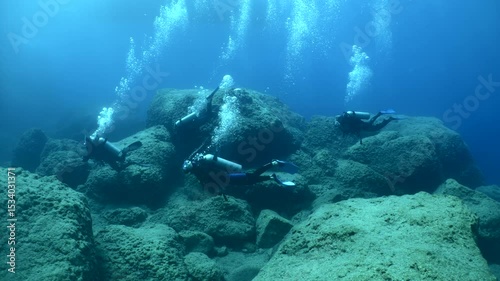 Wallpaper Mural underwater scenery of big rocks topography scuba divers exploring Torontodigital.ca