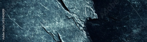 Textured surface of dark teal slate stone.