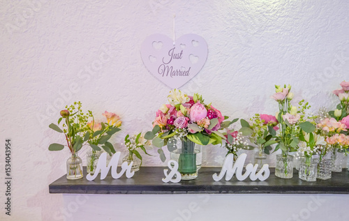 Wedding decor. Close up of a wedding table decoration with white and pink flowers and candles Wedding floristic concept