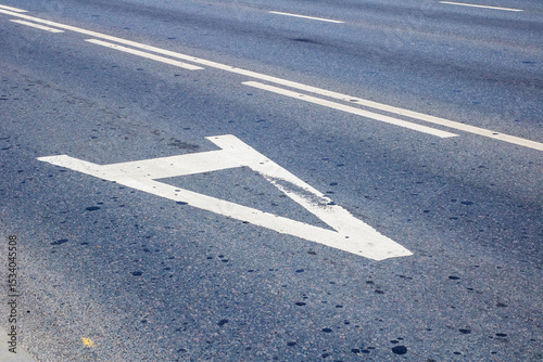 There is a white arrow that is painted on the side of the road