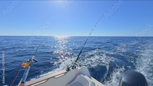 Sport boat trolling ocean with rods, reels, saltwater outboard fishing