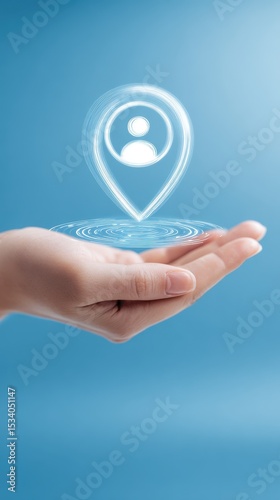 A female hand gently holds a glowing digital location pin icon with a person symbol inside a blue background