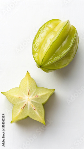 Freshly cut starfruit displayed on a white background ideal for wallpaper and food concepts