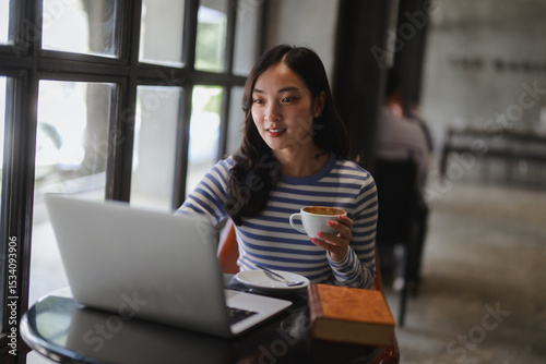 Freelancer working remotely in cafe, enjoying coffee and using laptop Free Download Freelancer working remotely in cafe, enjoying coffee and using laptop - GFXLoad