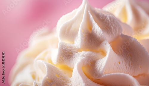 Cosmetic silky cream texture on a pink backdrop capturing a close-up view