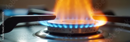 Kitchen gas cooker with burning blue and orange propane gas flames. Burner with high heat, cooking appliance, energy, power. Cooking home food on stove with flammable fire.