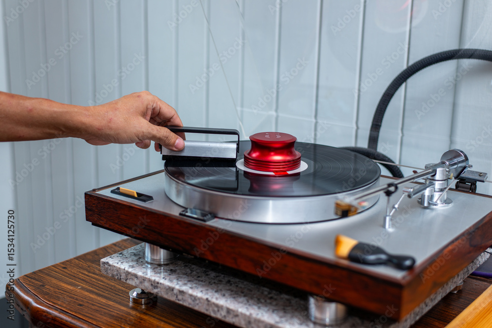 Obraz premium Cleaning Vinyl Record on Vintage Turntable