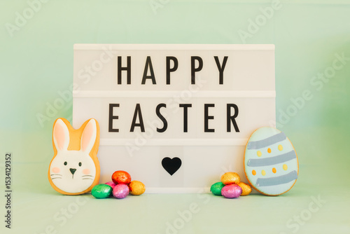 Happy Easter letter board with cookies and colorful chocolate eggs