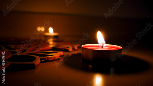 Warm tealight candles glow softly in a dark setting, creating a cozy and ambient atmosphere. Perfect for celebrations, relaxation, or romantic themes.