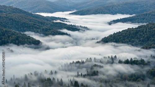 Serene landscape of misty mountains and valleys during the day. Time-lapse video  