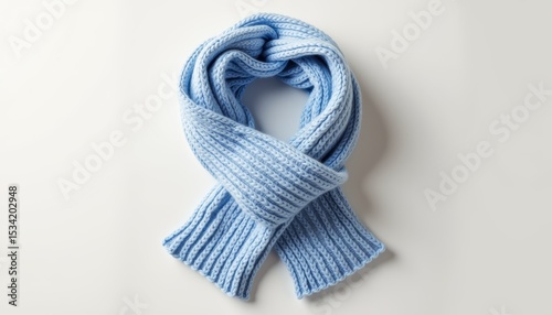 Thick, chunky winter scarf rolled into a ring on white background   photo