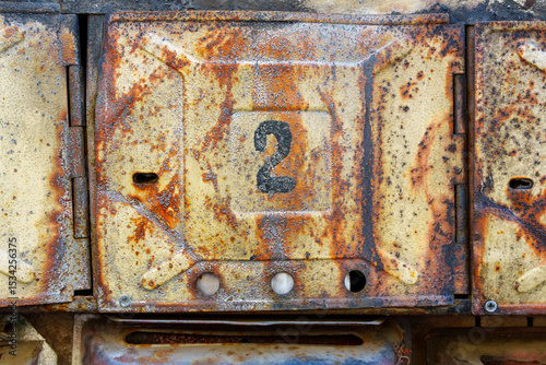 old post box on the wall of a building, old weathered paint