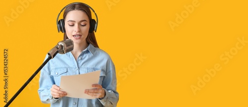 Tablou pe pânză Female radio presenter with microphone on yellow background with space for text