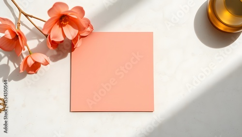 Muted coral memo square with faint gold flecks positioned on smooth limestone surface, styled for summer luxe