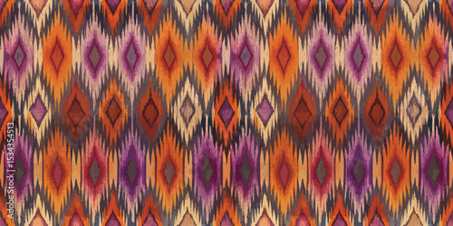 Vibrant geometric fabric pattern in warm tones of orange, purple, and brown.