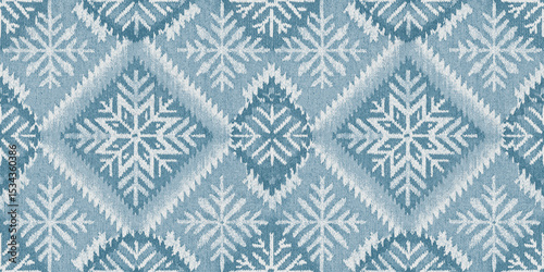 Intricate snowflake pattern in soft blue and white tones.