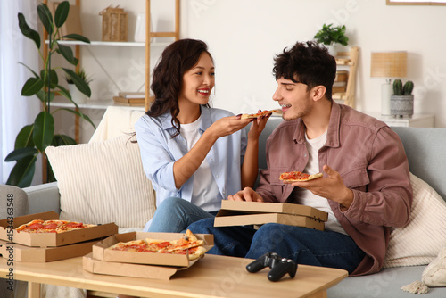 Young couple eating tasty p...